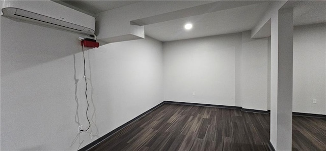 185 Glenrose Cir SW, Atlanta, GA 30354 - finished basement featuring an AC wall unit, dark wood-style flooring, baseboards, and recessed lighting
