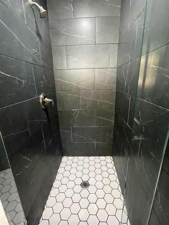 bathroom with a tile shower
