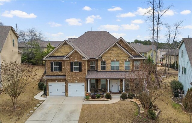 craftsman house featuring a porch and a garage