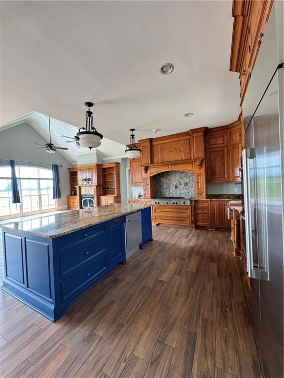 311 Langston Rd SE, Calhoun, GA 30701 - kitchen featuring stainless steel appliances, dark wood-type flooring, blue cabinetry, a spacious island, and ceiling fan