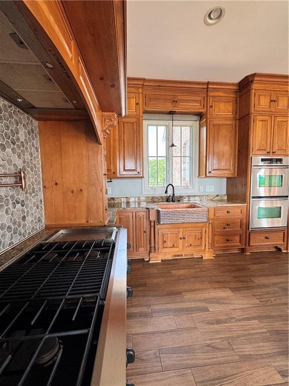 311 Langston Rd SE, Calhoun, GA 30701 - kitchen with premium range hood, appliances with stainless steel finishes, light countertops, a sink, and dark wood-style floors