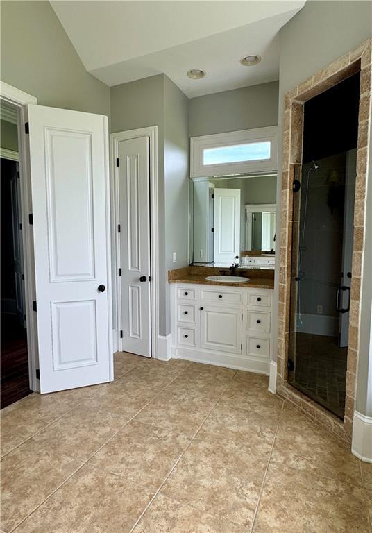 311 Langston Rd SE, Calhoun, GA 30701 - full bath featuring vanity, a stall shower, and tile patterned flooring
