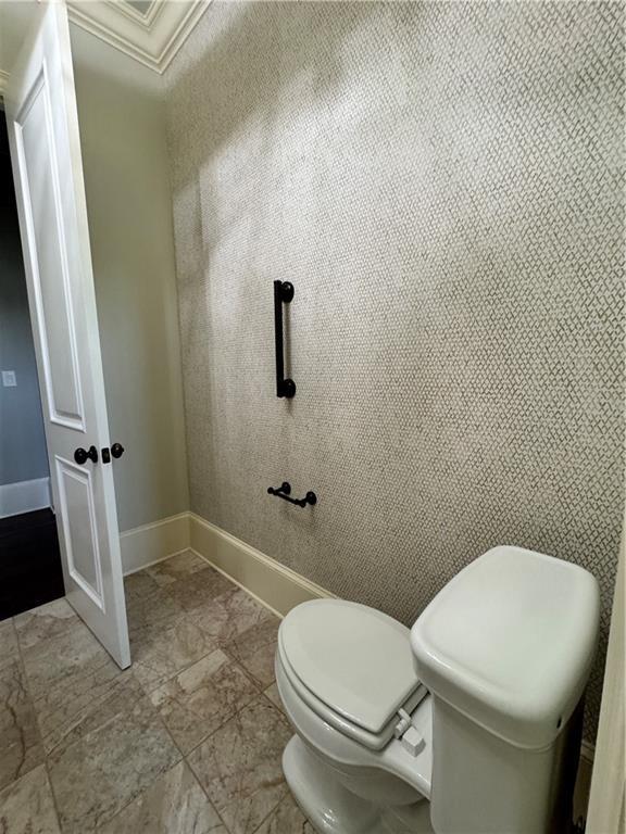 311 Langston Rd SE, Calhoun, GA 30701 - bathroom featuring toilet, crown molding, and baseboards