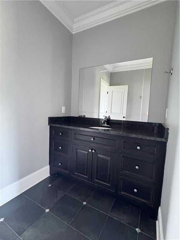 311 Langston Rd SE, Calhoun, GA 30701 - bathroom with crown molding, vanity, baseboards, and tile patterned flooring