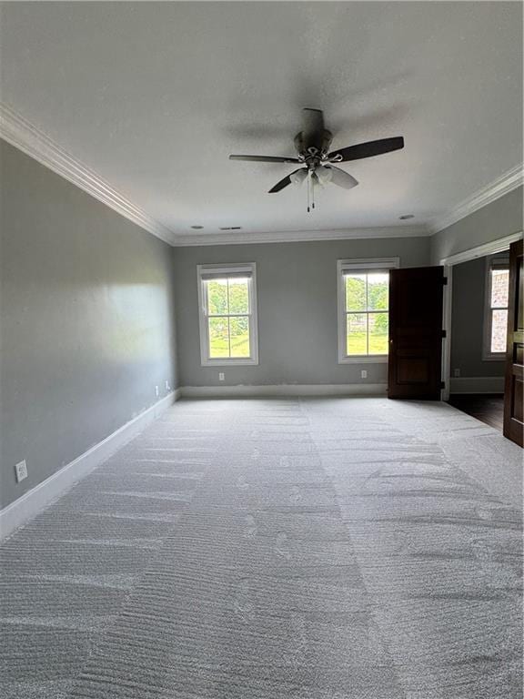 311 Langston Rd SE, Calhoun, GA 30701 - spare room featuring plenty of natural light, a ceiling fan, crown molding, baseboards, and light colored carpet