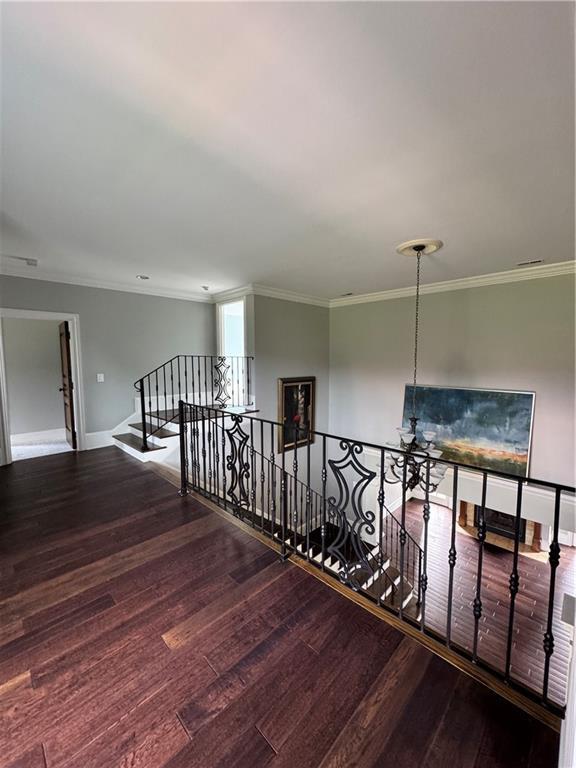 311 Langston Rd SE, Calhoun, GA 30701 - hallway featuring an upstairs landing, wood finished floors, ornamental molding, and baseboards