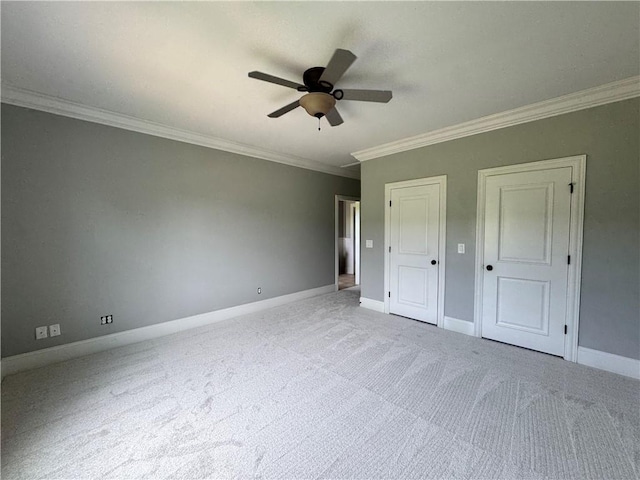 311 Langston Rd SE, Calhoun, GA 30701 - unfurnished bedroom featuring carpet, ornamental molding, baseboards, a ceiling fan, and multiple closets