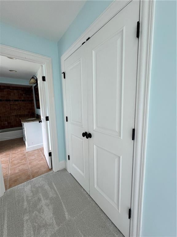 311 Langston Rd SE, Calhoun, GA 30701 - hallway with light tile patterned floors, baseboards, and light carpet