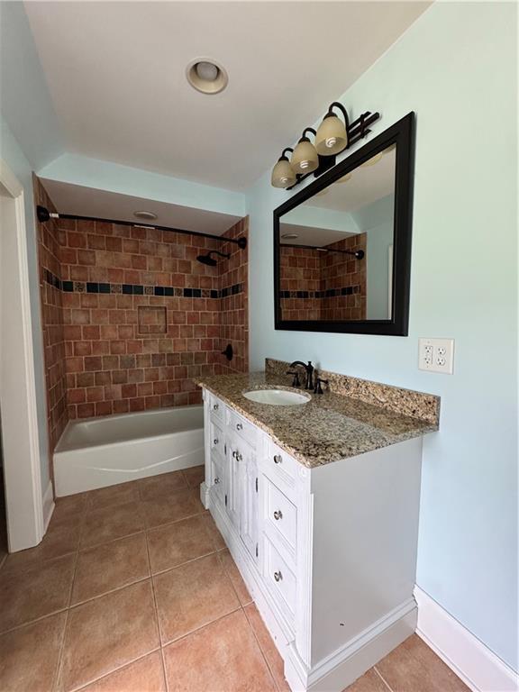311 Langston Rd SE, Calhoun, GA 30701 - full bathroom with vanity, tile patterned flooring, and washtub / shower combination