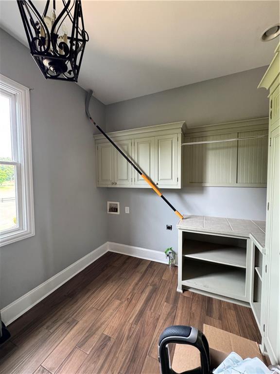 311 Langston Rd SE, Calhoun, GA 30701 - laundry area with a chandelier, baseboards, dark wood-type flooring, and hookup for a washing machine