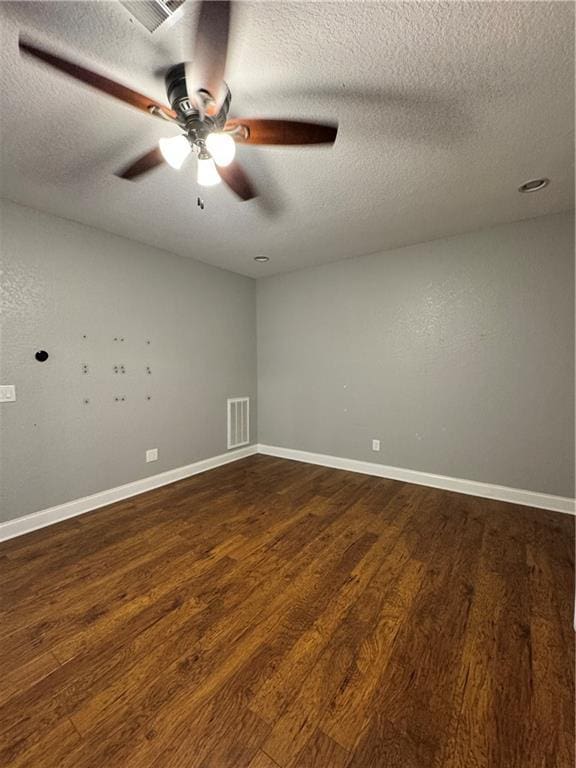 311 Langston Rd SE, Calhoun, GA 30701 - unfurnished room featuring dark wood finished floors, a textured ceiling, a ceiling fan, and baseboards