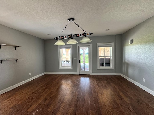 311 Langston Rd SE, Calhoun, GA 30701 - unfurnished dining area with baseboards, a textured ceiling, and dark wood-style floors