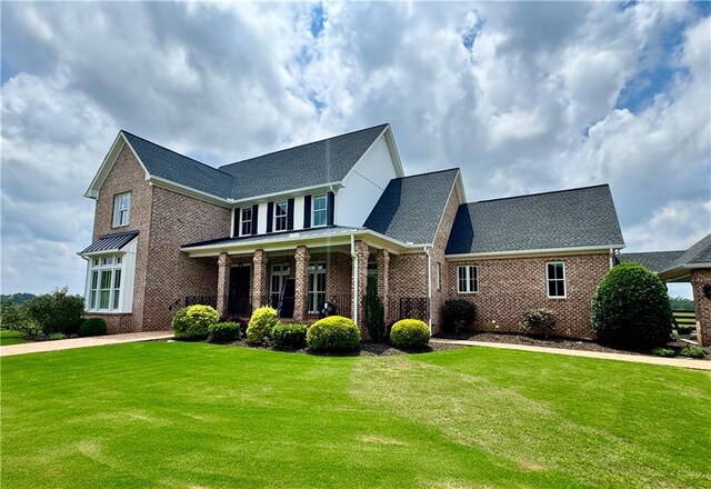 311 Langston Rd SE, Calhoun, GA 30701 - view of front of home with brick siding, a front lawn, and a shingled roof