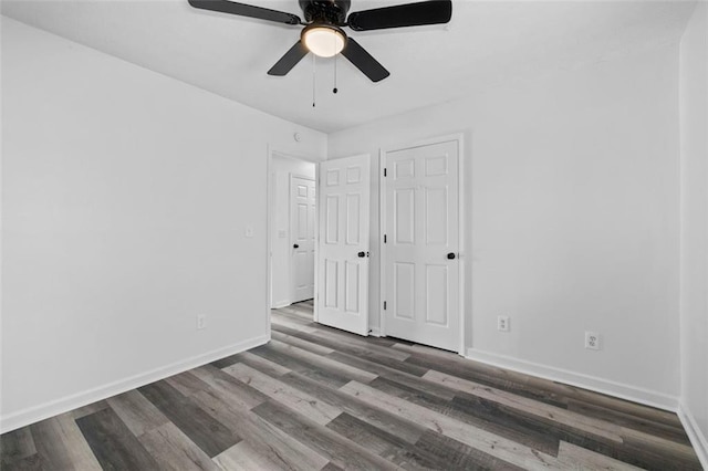 2571 Hamill Dr, Buford, GA 30519 - unfurnished bedroom featuring baseboards, wood finished floors, and a ceiling fan