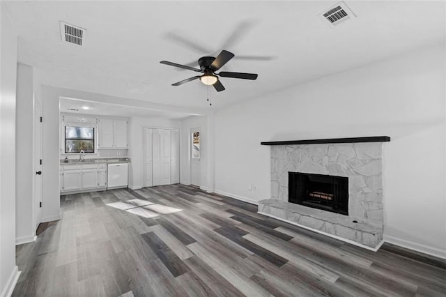 2571 Hamill Dr, Buford, GA 30519 - unfurnished living room featuring wood finished floors, a ceiling fan, baseboards, and a fireplace
