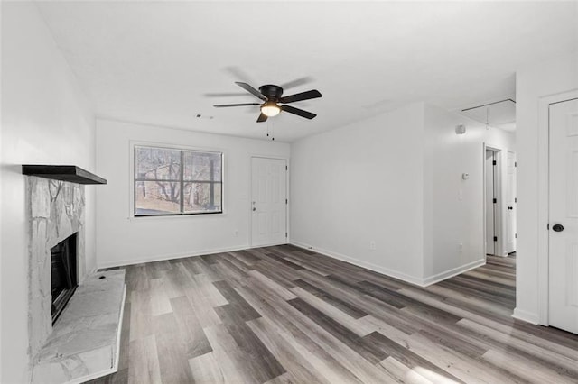 2571 Hamill Dr, Buford, GA 30519 - unfurnished living room featuring attic access, ceiling fan, wood finished floors, a premium fireplace, and baseboards