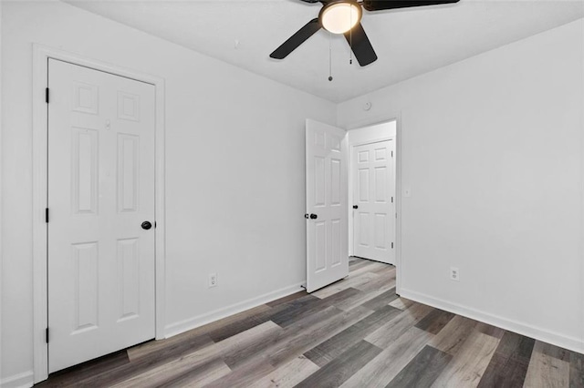 2571 Hamill Dr, Buford, GA 30519 - unfurnished bedroom featuring wood finished floors, baseboards, and ceiling fan