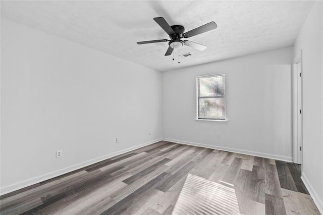 2571 Hamill Dr, Buford, GA 30519 - unfurnished room with wood finished floors, a textured ceiling, ceiling fan, and baseboards