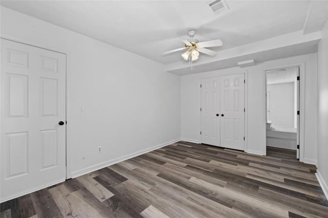 2571 Hamill Dr, Buford, GA 30519 - unfurnished bedroom featuring wood finished floors, baseboards, ceiling fan, and a closet