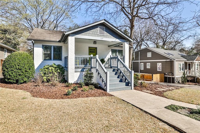 bungalow-style house featuring brick siding and a porch