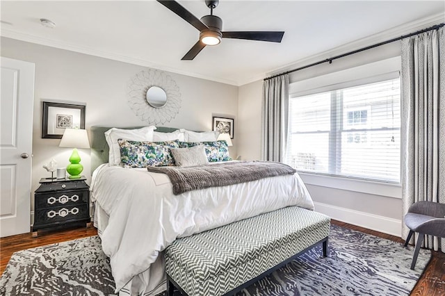 bedroom with baseboards, wood finished floors, and ornamental molding