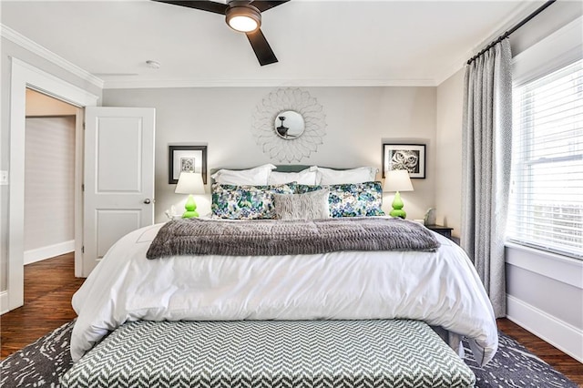 bedroom with ornamental molding, baseboards, and wood finished floors