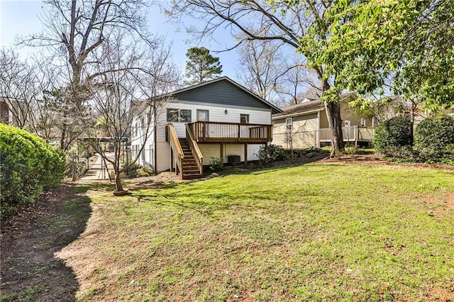 back of property featuring a yard, stairway, and a deck