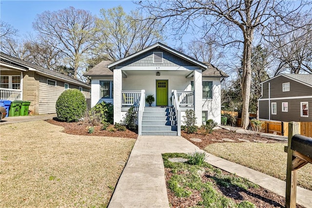 bungalow with a porch and a front yard