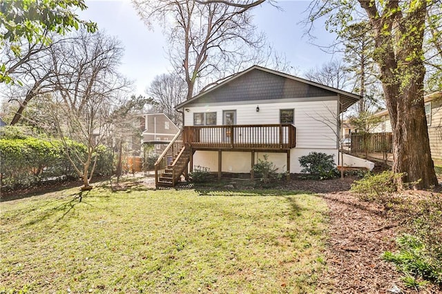 rear view of property with stairway, a lawn, and a deck