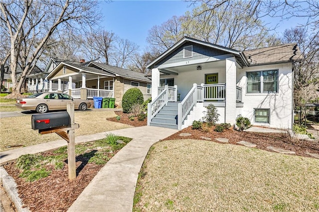 bungalow-style house with a porch and a front yard