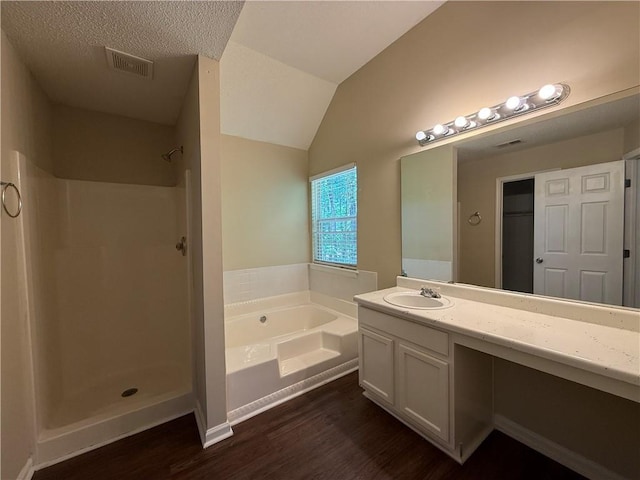 bathroom with a garden tub, visible vents, vanity, wood finished floors, and walk in shower