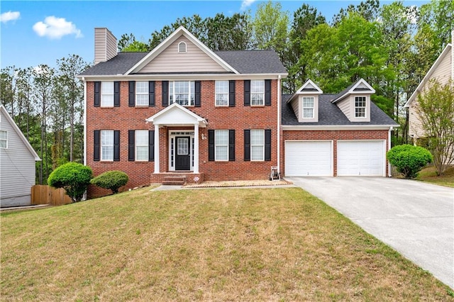 642 Towering Pine Trl, Lawrenceville, GA 30045 - colonial home featuring an attached garage, concrete driveway, a chimney, brick siding, and roof with shingles