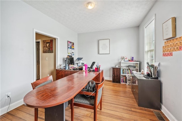 642 Towering Pine Trl, Lawrenceville, GA 30045 - dining space featuring a textured ceiling, a desk, light wood-style flooring, and baseboards