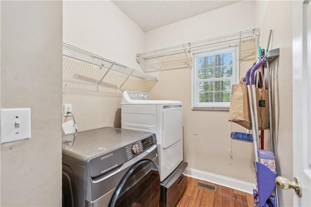 642 Towering Pine Trl, Lawrenceville, GA 30045 - laundry area featuring washing machine and clothes dryer, wood finished floors, and baseboards