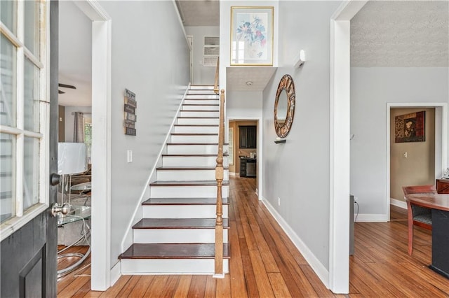642 Towering Pine Trl, Lawrenceville, GA 30045 - stairs featuring hardwood / wood-style flooring, baseboards, and a ceiling fan