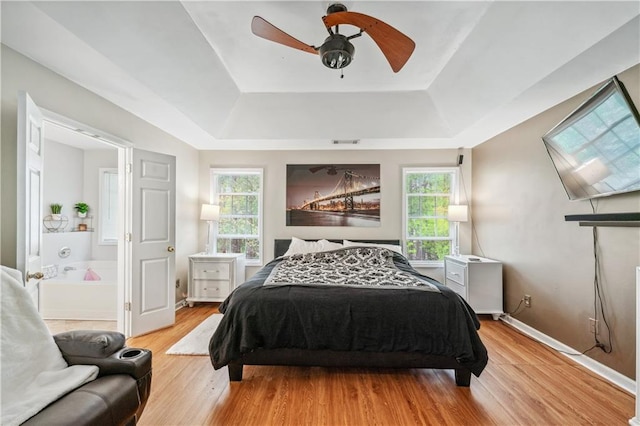 642 Towering Pine Trl, Lawrenceville, GA 30045 - bedroom with a tray ceiling, wood finished floors, baseboards, and ceiling fan