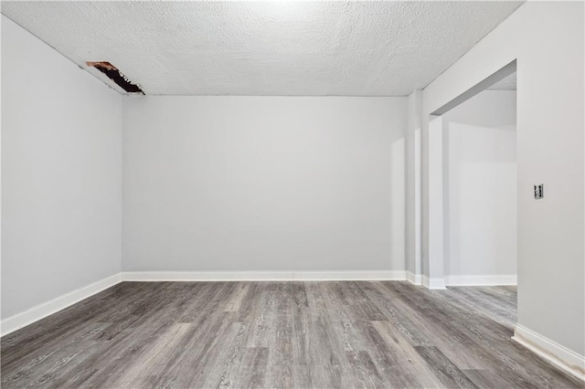 642 Towering Pine Trl, Lawrenceville, GA 30045 - empty room featuring wood finished floors, a textured ceiling, and baseboards