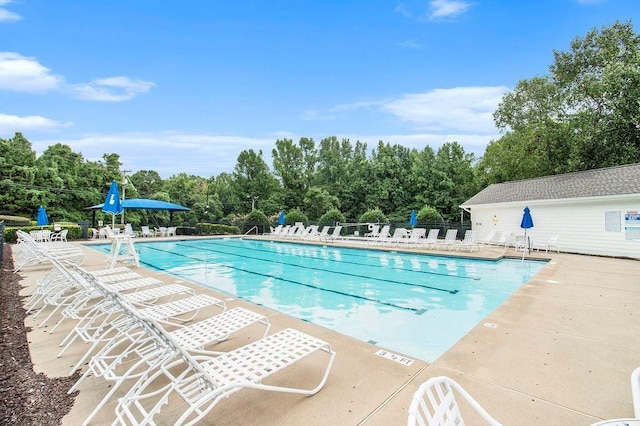 642 Towering Pine Trl, Lawrenceville, GA 30045 - community pool with fence, a patio, and view of wooded area