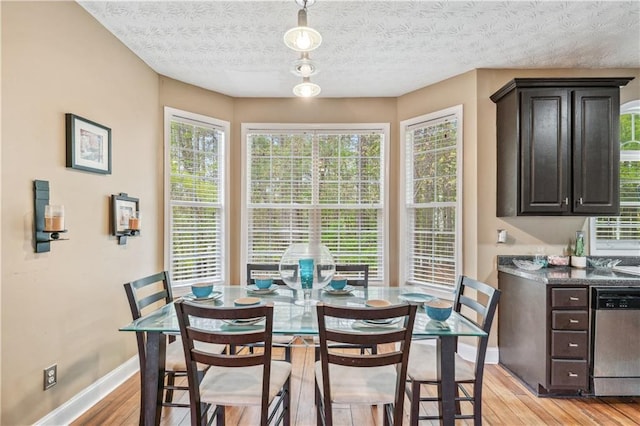 642 Towering Pine Trl, Lawrenceville, GA 30045 - dining room featuring baseboards, light wood-type flooring, and plenty of natural light