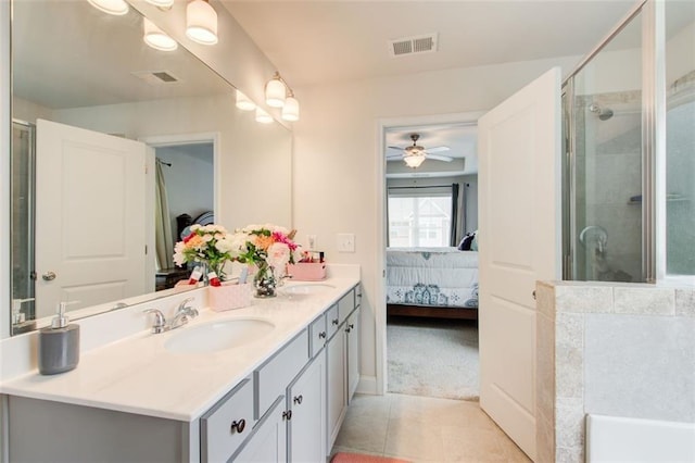 ensuite bathroom with visible vents, a sink, a shower stall, and ensuite bath