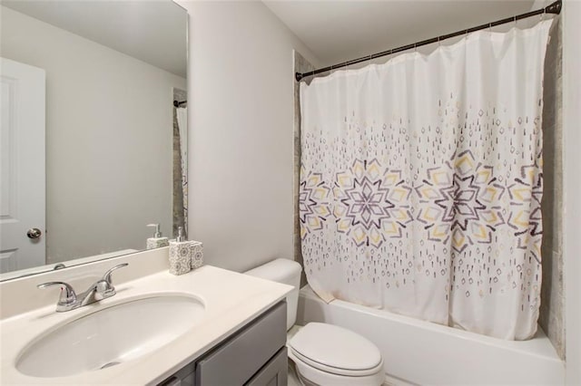 bathroom with shower / bath combo, vanity, and toilet