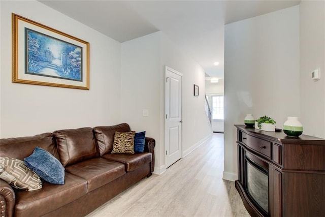 living room with light wood-style flooring and baseboards