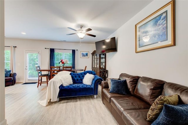 living area featuring a ceiling fan and light wood-style floors