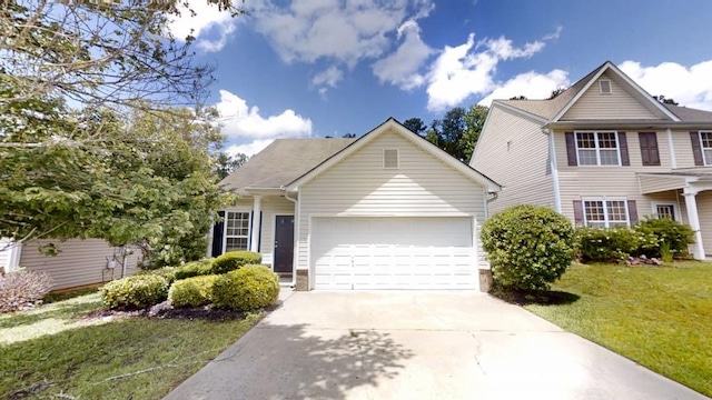 view of front of property featuring an attached garage, driveway, and a front yard
