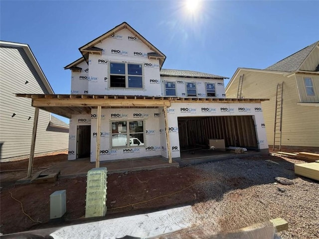 property under construction with a garage and gravel driveway