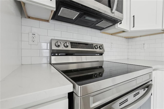 1500 Murphy Ave SW, Atlanta, GA 30310 - kitchen featuring appliances with stainless steel finishes, tasteful backsplash, white cabinets, and light stone countertops