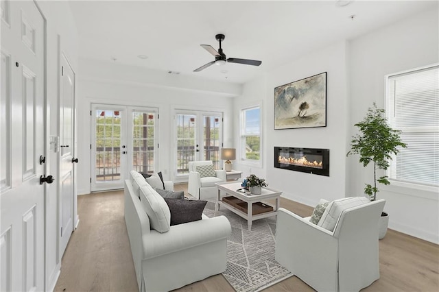 1500 Murphy Ave SW, Atlanta, GA 30310 - living room with light wood finished floors, french doors, a glass covered fireplace, and a ceiling fan