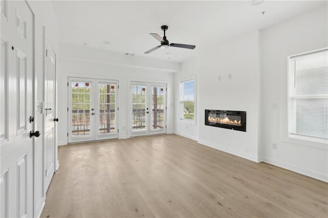 1500 Murphy Ave SW, Atlanta, GA 30310 - unfurnished living room with french doors, light wood-type flooring, ceiling fan, a glass covered fireplace, and baseboards