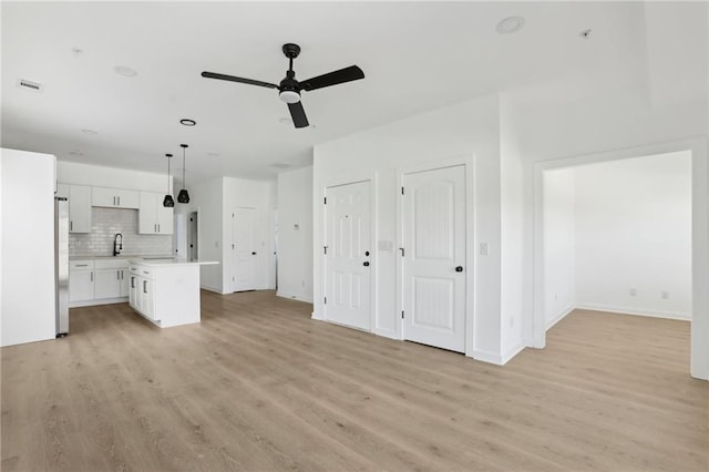 1500 Murphy Ave SW, Atlanta, GA 30310 - unfurnished living room with a sink, a ceiling fan, light wood-style flooring, and baseboards