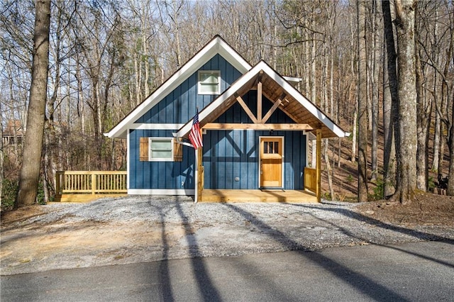 view of front of property with a wooded view and board and batten siding